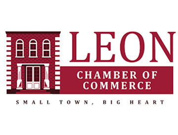 Logo for Leon Chamber of Commerce featuring a red brick building illustration and the text: “LEON Chamber of Commerce. Small Town, Big Heart.”.